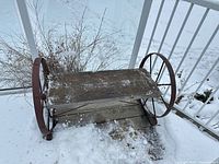 Three-quarter view of entire bench on snowy deck
