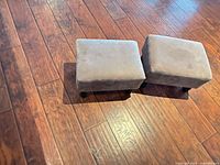 Both footstools top view showing upholstery and size