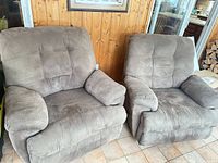Front view of both taupe microfiber recliners showing upholstery, tufting and overall condition