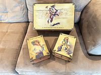 All three boxes on sofa, showing printed lids and size comparison