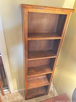 Full front view of tall bookcase showing five shelves