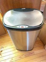 Front view closed lid showing stainless body and sensor panel