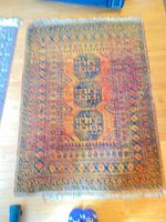 Orange and navy rug full view with fringe