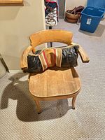 wooden armchair front view with cushion on seat