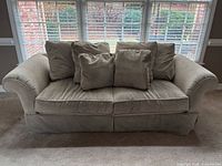 Front view of beige sofa with cushions