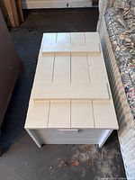 Closed view of white painted wooden trunk top and exterior