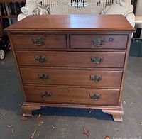 Front view of five-drawer pine dresser showing drawers, hardware and feet