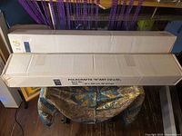 Two long cardboard boxes containing beaded door curtains