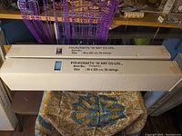 Both boxed beaded curtains on table showing full boxes