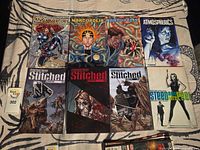 Group shot of all eight comics spread on cloth