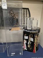 Overall view: acrylic cabinet next to True Utility display stand with necklaces