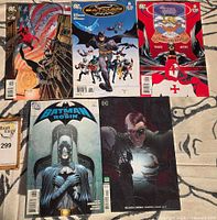 Five Batman-related DC comic books laid out