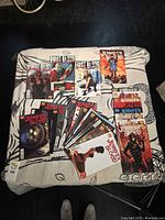 All comics spread on bed showing main and prequel series covers