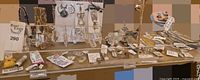 Full display of toe rings, pendants, crystal prisms, earrings and chains on tabletop