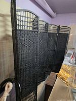 Full view of two black rattan folding screens stacked