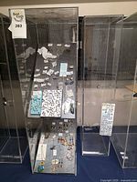 Full glass display case showing pinned jewelry assortment
