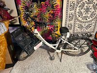 Left side view of white TAOTAOBIKES e-bike with front crate basket and rear rack