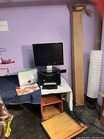 Overall view of monitor on stand with computer, lamp, bamboo screen