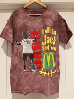 Front view of Travis Scott Cactus Jack McDonalds tie-dye T-shirt on hanger