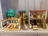 Full view of classroom building, tree trunk, house, furniture and figures