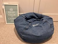 Beanbag chair beside framed poster