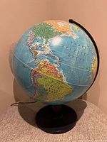 Full view of illuminated globe on base