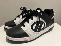 Side profile of both shoes showing color, logo and laces