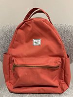 Front view showing color, logo patch, front zip pocket