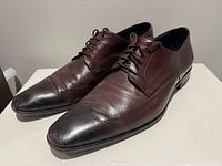 Top/front view of both brown leather shoes showing overall style, toe shape and lacing