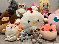 Front close-up of central plush toys showing chick, cow/moose, cat, unicorn and others