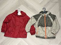 Both jackets laid flat showing overall front view