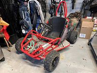 Full view of red Lifan go-kart showing frame, seat, tires and roll bar