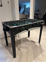 Three-quarter view of MD Sports foosball table showing overall condition and size