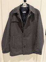Full view of grey Strellson coat on hanger