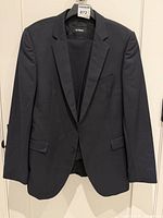 Front view of navy suit jacket on hanger