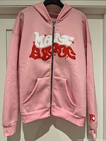Full front view of pink zip-front hoodie on hanger