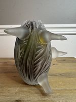 Front view showing three frosted protrusions and carved surface