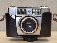 Front view of Agfa Agfamatic camera in case showing lens and logo
