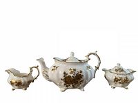 Front view of teapot, creamer and sugar bowl showing pattern and form
