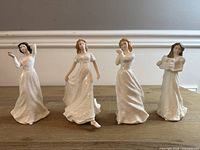 Front view of four Royal Doulton figurines