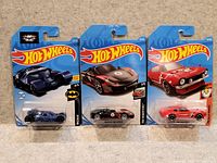 Front view of all three sealed Hot Wheels cars on cards