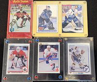 Six hockey cards in holders
