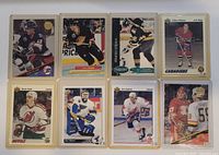 Front view of all eight hockey cards in sleeves