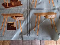 Box artwork showing assembled wooden table with drawer