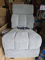 front view of gray heated massage recliner seat with remote on cushion