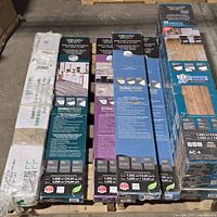 Stack of eight sealed flooring boxes on pallet