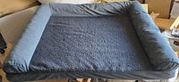 Full view of rectangular pet bed showing fleece center and bolster sides