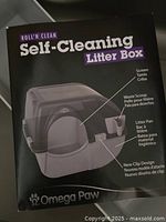 Product booklet showing Omega Paw Roll'N Clean Self-Cleaning Litter Box