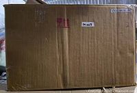 Sealed cardboard shipping box containing the mirror