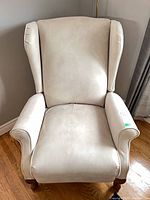 Front view of upholstered wingback armchair